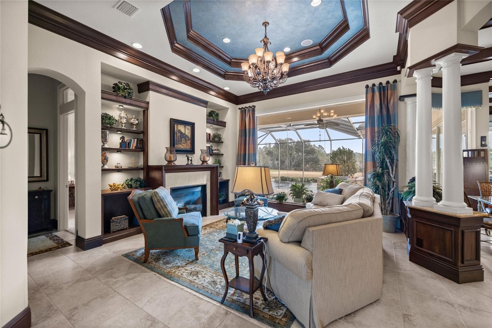 Formal living room overlooking pool and golf course - 6861 SW 179TH AVENUE RD, DUNNELLON