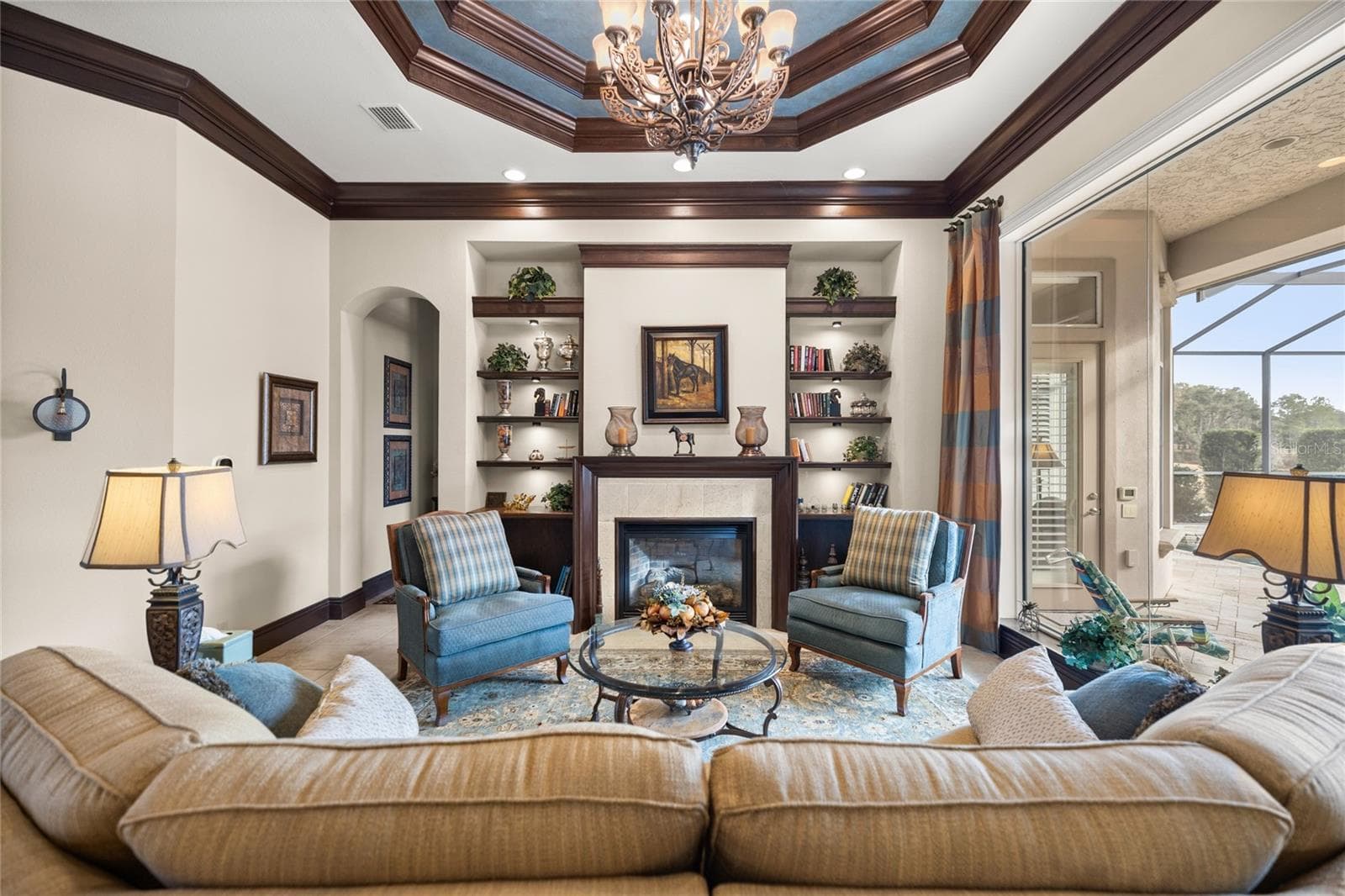 Formal living room overlooking pool and golf course - 6861 SW 179TH AVENUE RD, DUNNELLON