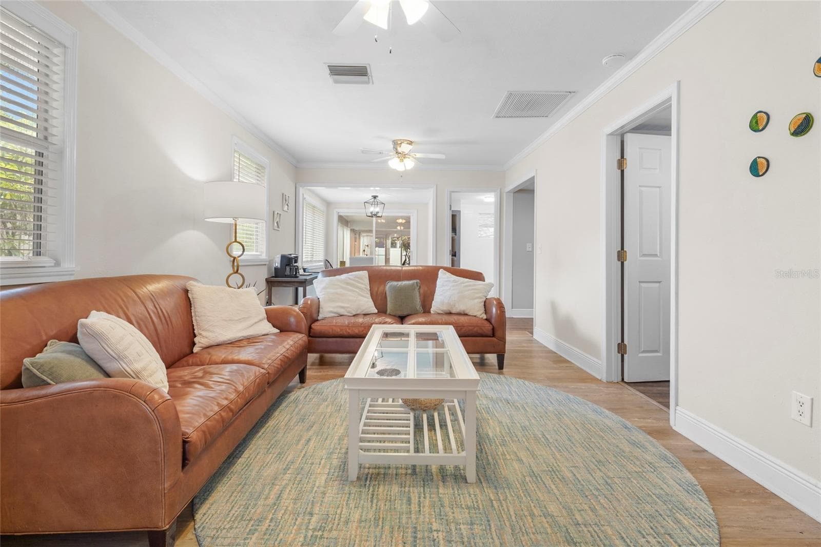 The heart of the home features an open layout with newer floors, crown molding, and plenty of natural light, perfect for relaxing or entertaining. - 2705 2ND AVE W, BRADENTON