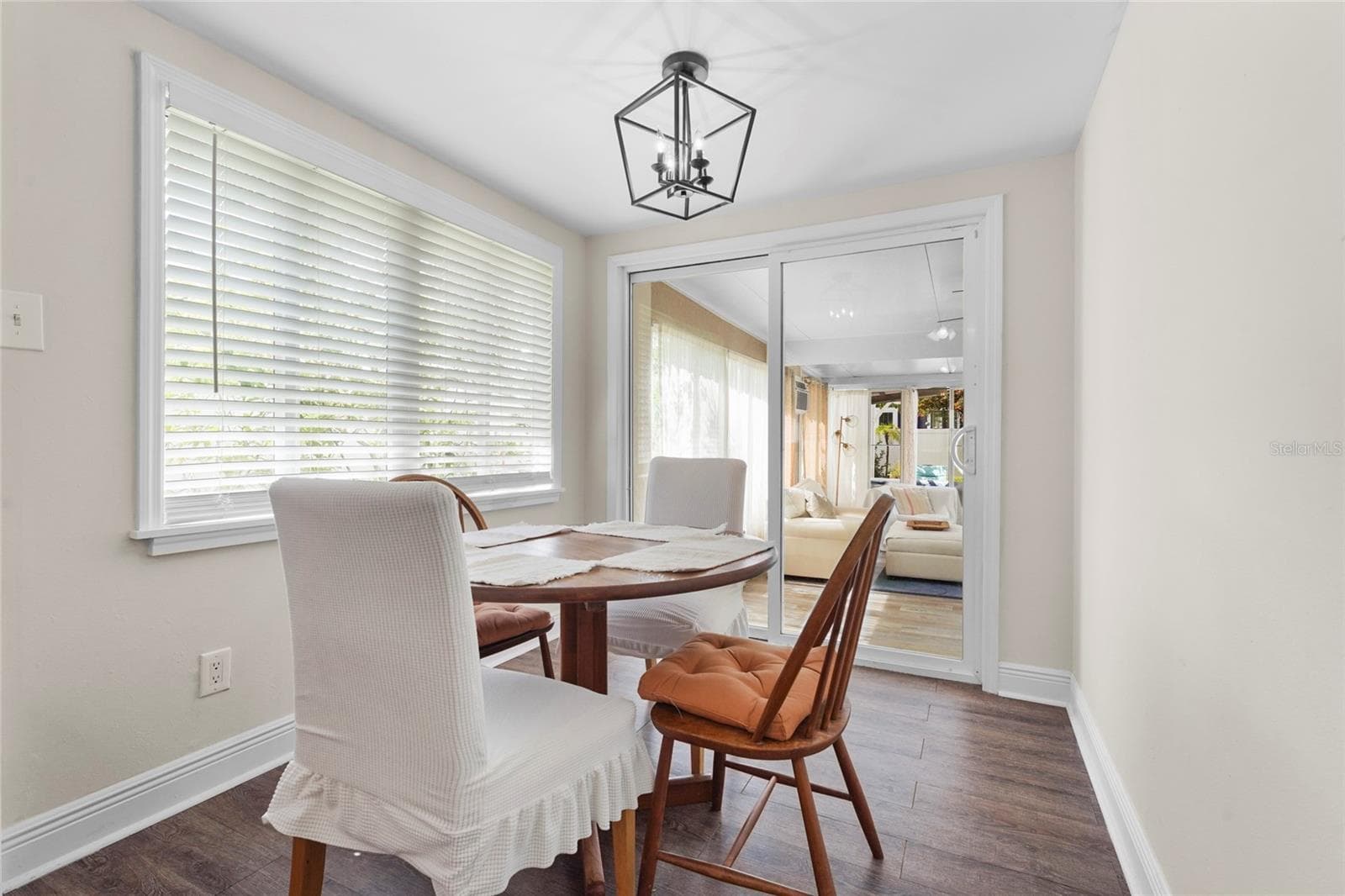 Dining Area with Natural Light – The bright dining space overlooks the backyard and Florida room, complete with updated lighting and a cozy breakfast nook feel. - 2705 2ND AVE W, BRADENTON