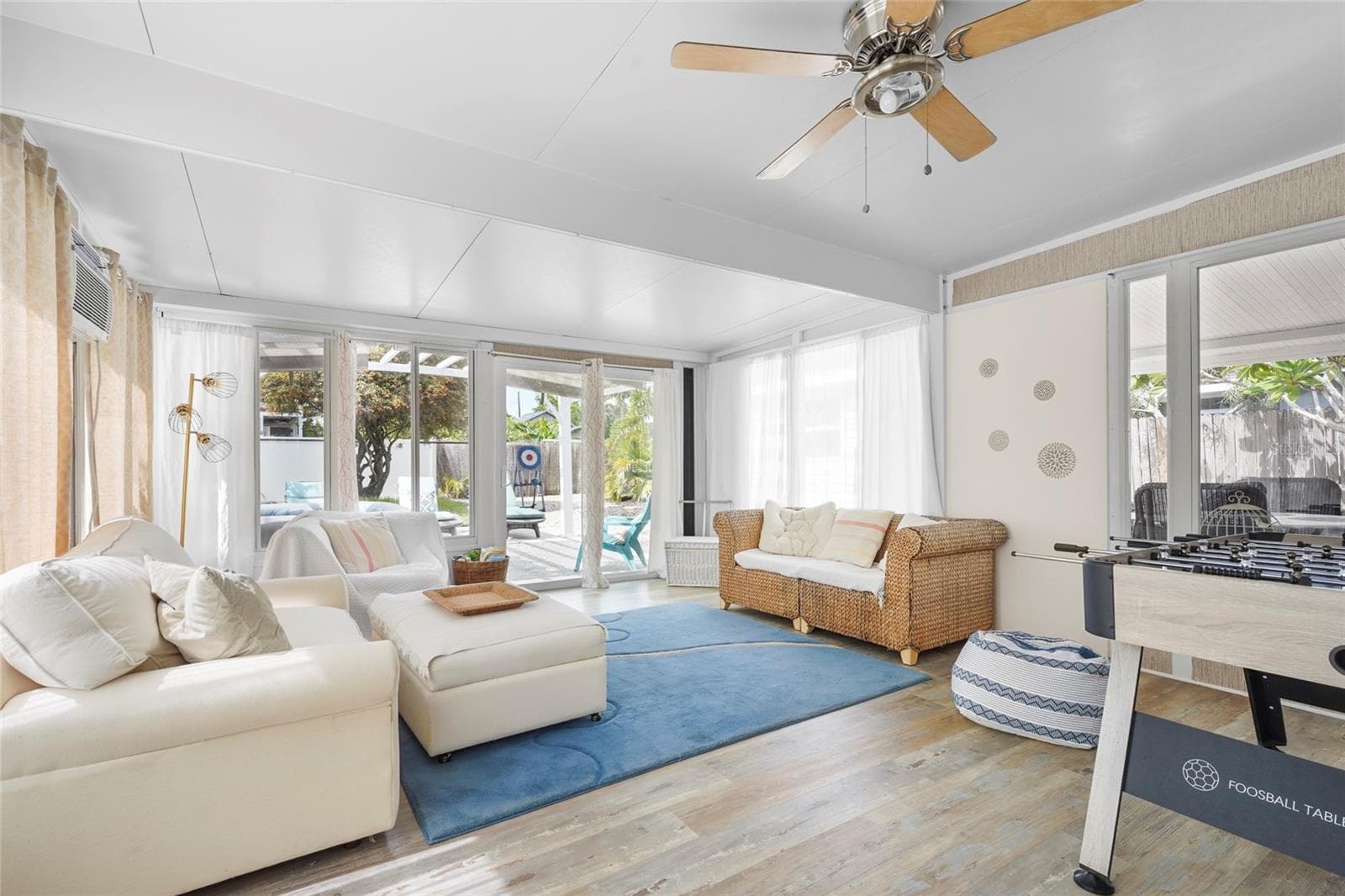 ?Bonus Game Room + Lounge – The large Florida room at the rear of the home offers plenty of room to unwind, host guests, or enjoy foosball and lounge seating with views of the private backyard. - 2705 2ND AVE W, BRADENTON