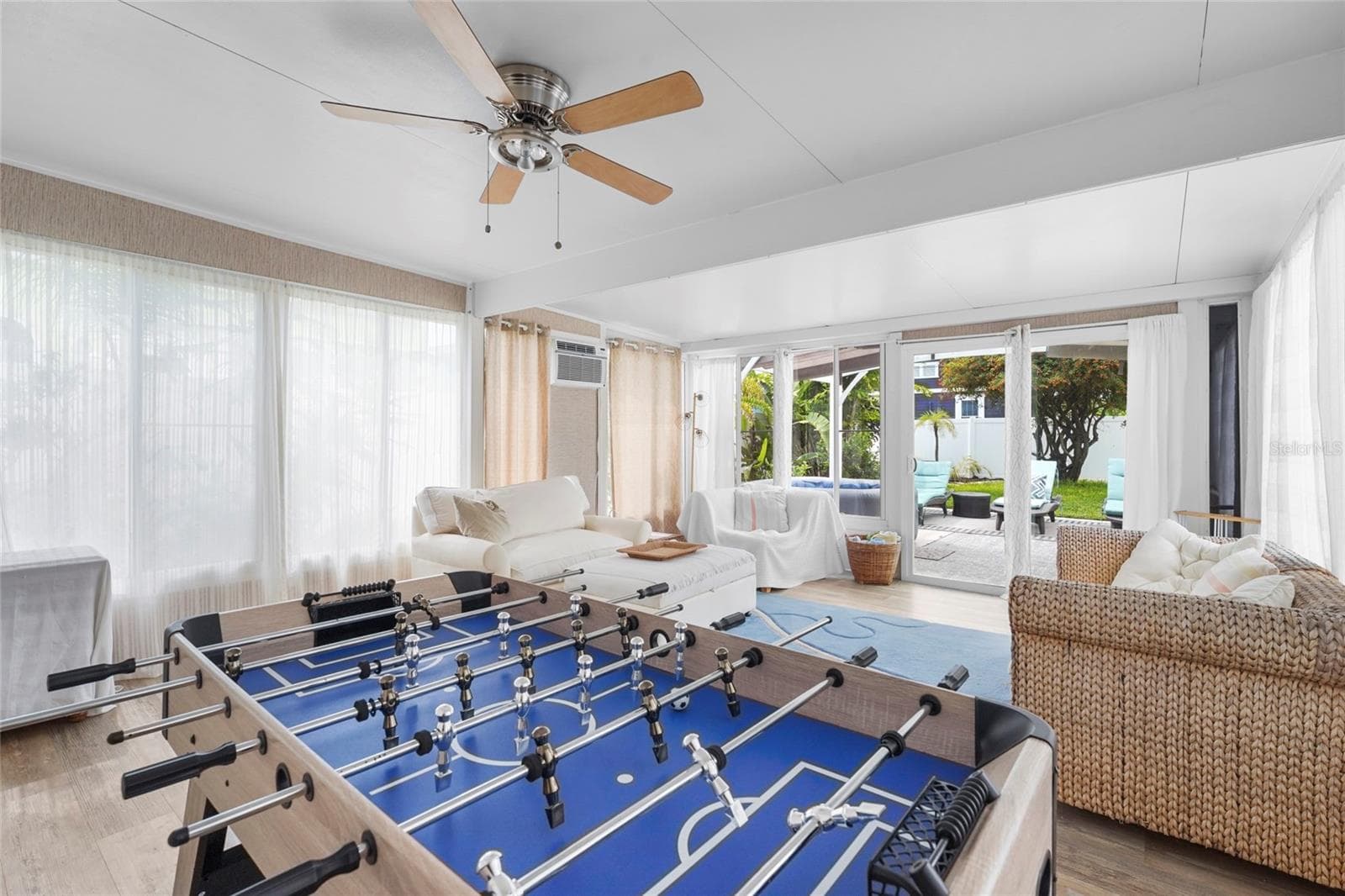 ?Bonus Game Room + Lounge – The large Florida room at the rear of the home offers plenty of room to unwind, host guests, or enjoy foosball and lounge seating with views of the private backyard. - 2705 2ND AVE W, BRADENTON