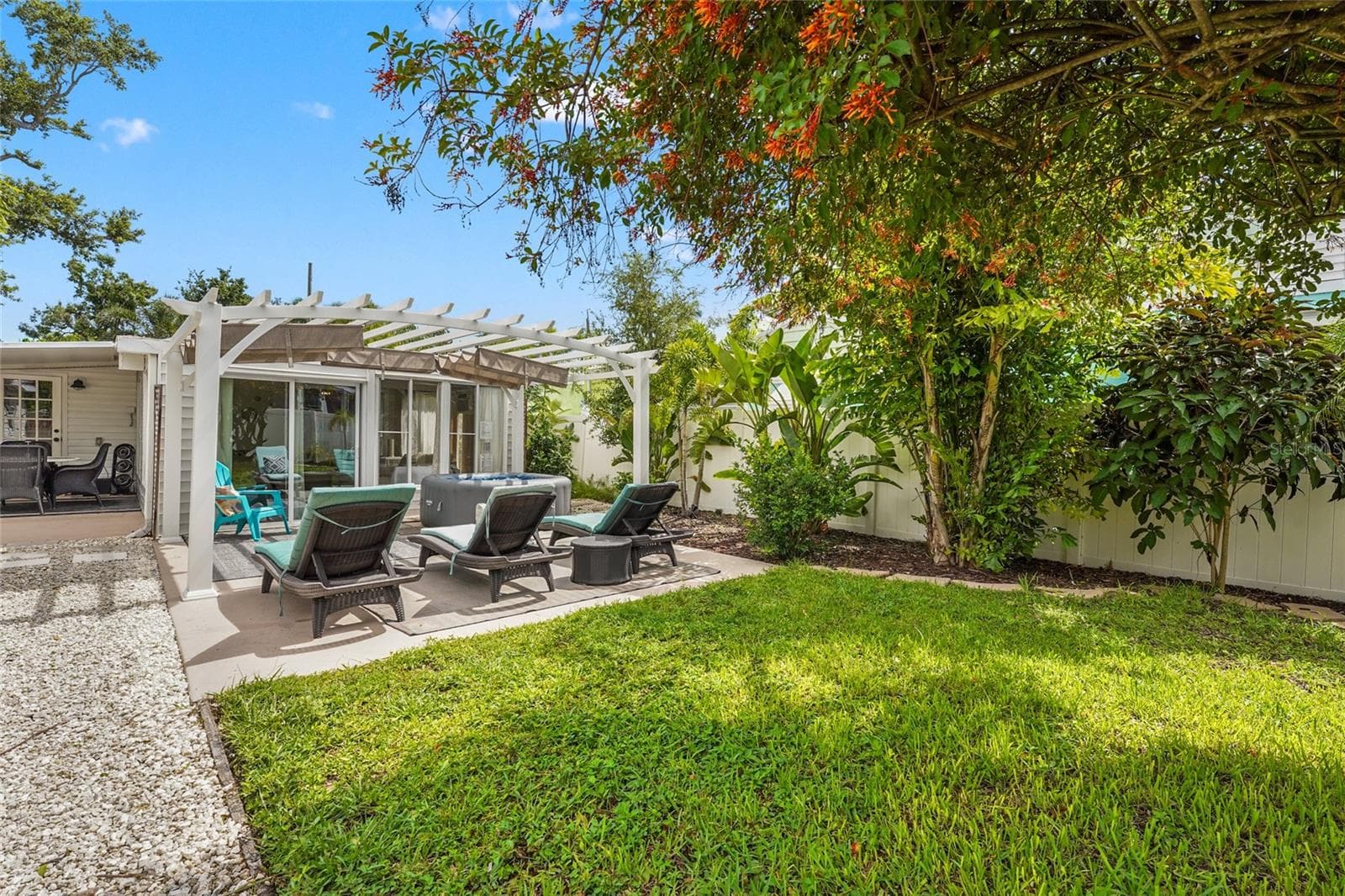 Lush + Private Yard – The backyard delivers privacy and natural beauty with vibrant plantings, a shaded lawn, and a peaceful retreat feel perfect for entertaining or Airbnb guests. - 2705 2ND AVE W, BRADENTON
