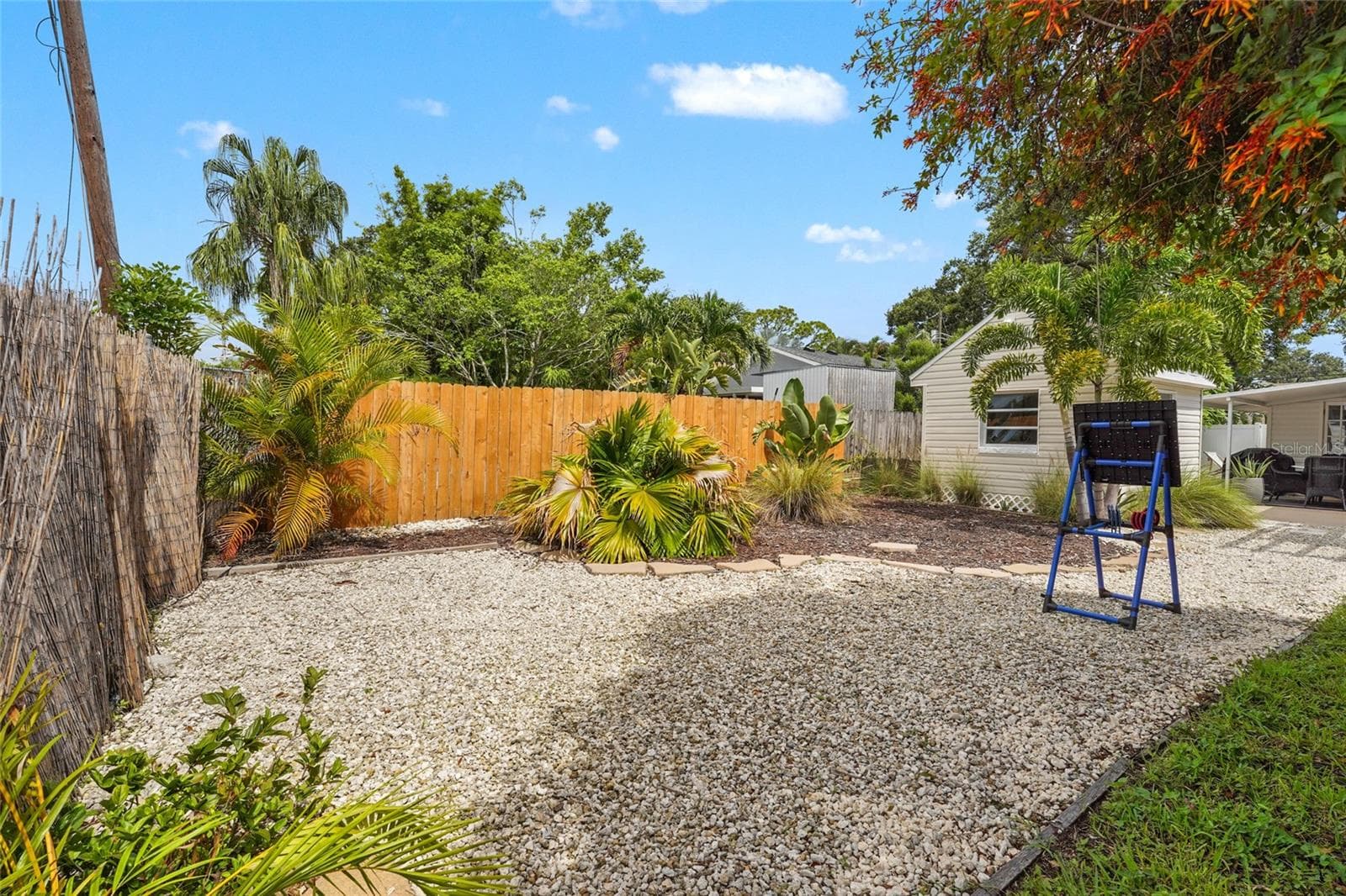 Bonus Backyard Zone – A private gravel-lined area offers flexibility for a fire pit, hammock setup, or additional seating. Mature palms and fencing create a serene Florida vibe. - 2705 2ND AVE W, BRADENTON