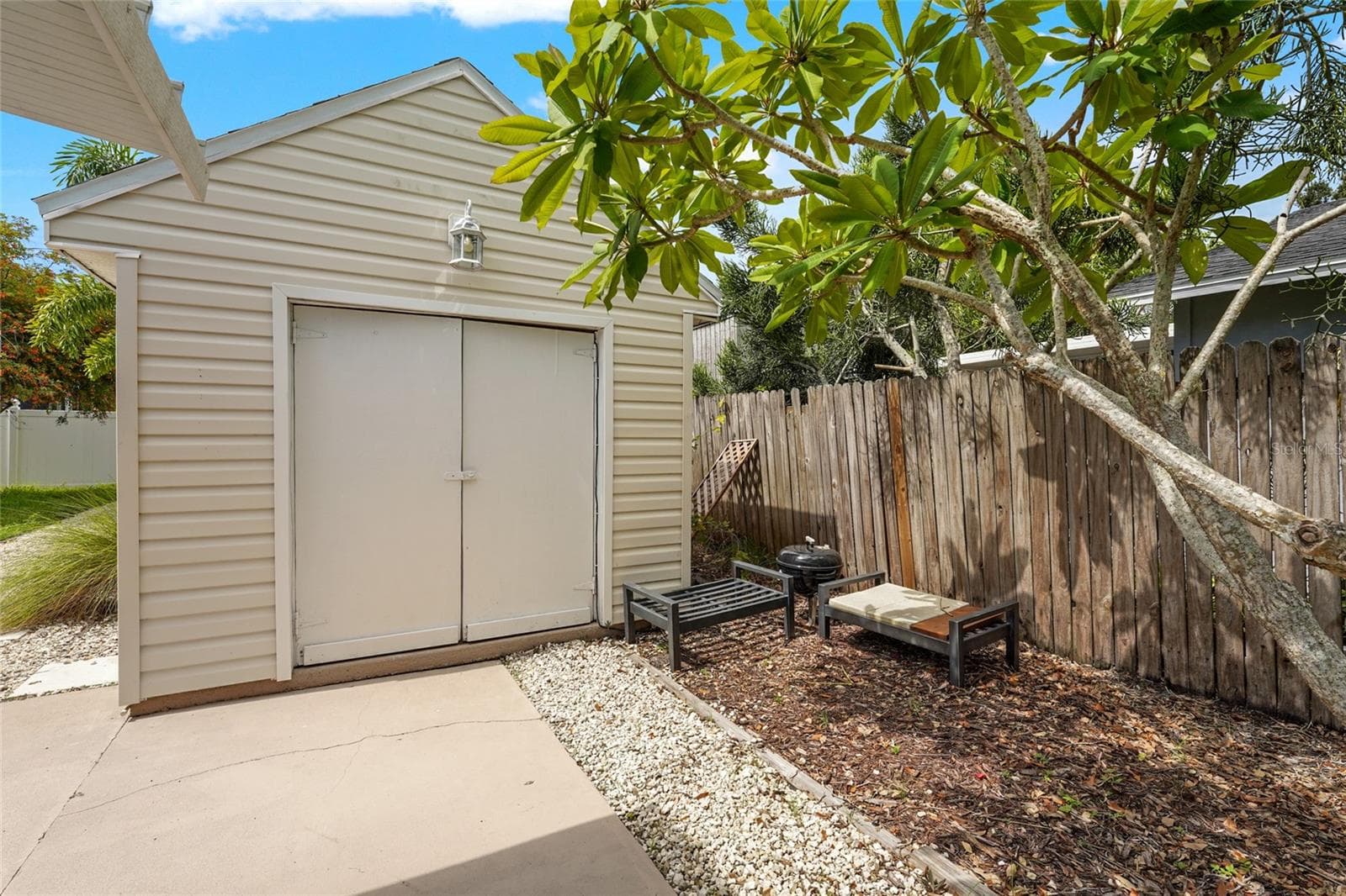 Powered Storage Shed – A spacious detached shed with double doors and electricity offers ideal storage for beach gear, bikes, tools, or even potential workshop space. - 2705 2ND AVE W, BRADENTON