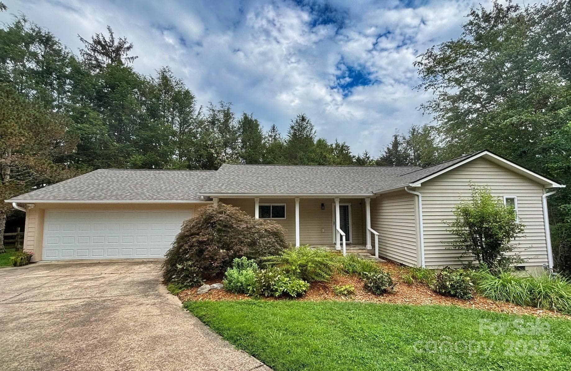 Beautiful landscaping accents the home and provides a haven for an abundance of wildlife. The architectural shingle roof was completed in July 2025. - Asheville