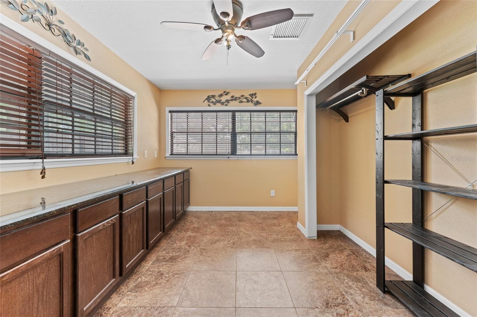 Office is 12' x 8', with ceramic tile, built-in cabinets, storage closet, and a ceiling fan. - 3011 LAKE ELLEN DR, TAMPA