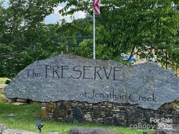Sign with American flag pole - Waynesville