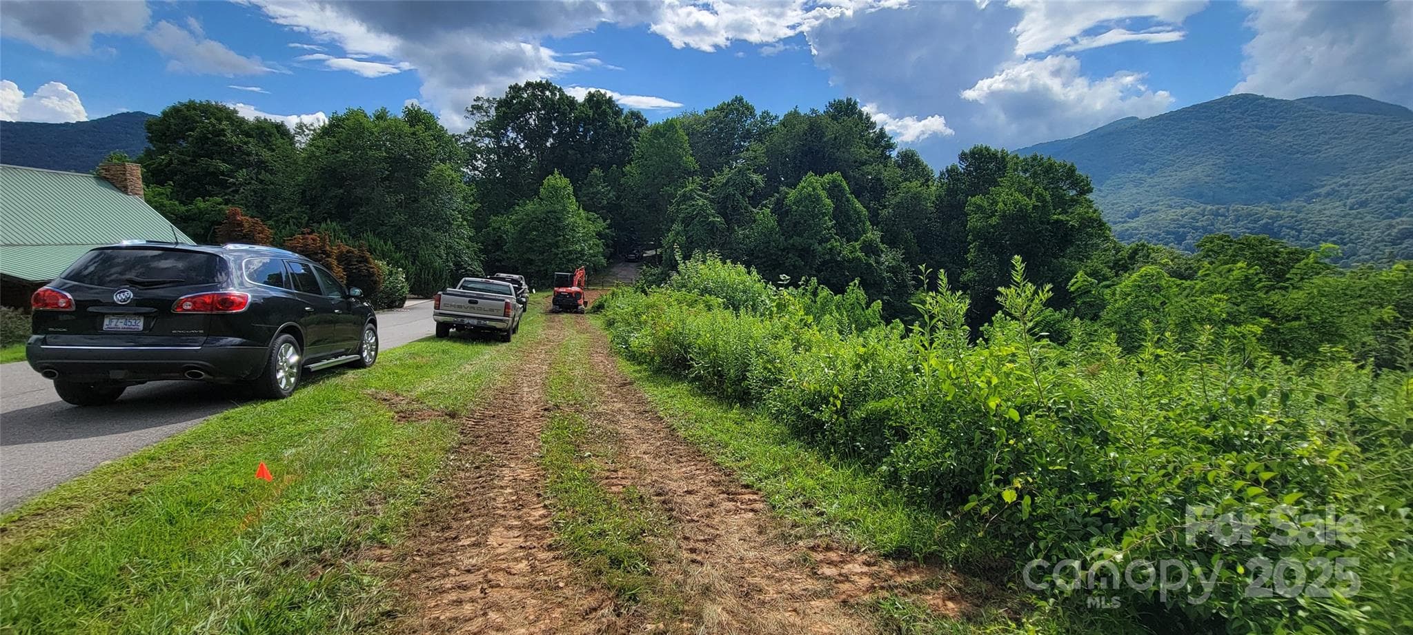 Lot 37 is located between SUV and Excavator.  Red flag is location of UG Elec running parallel with 18 ft wide subd street - Waynesville