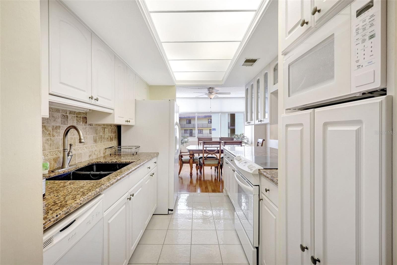 The kitchen has granit counter, dual sink, Range, Dishwasher, Microwave andlots of storage and leads directly to the dining area - 660 ISLAND WAY #708, CLEARWATER BEACH