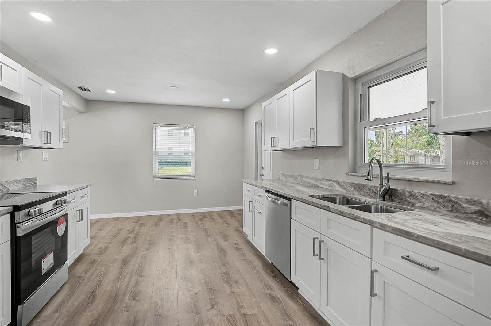 Eat In Kitchen and Door Leading to Carport - 102 20TH ST NE, BRADENTON
