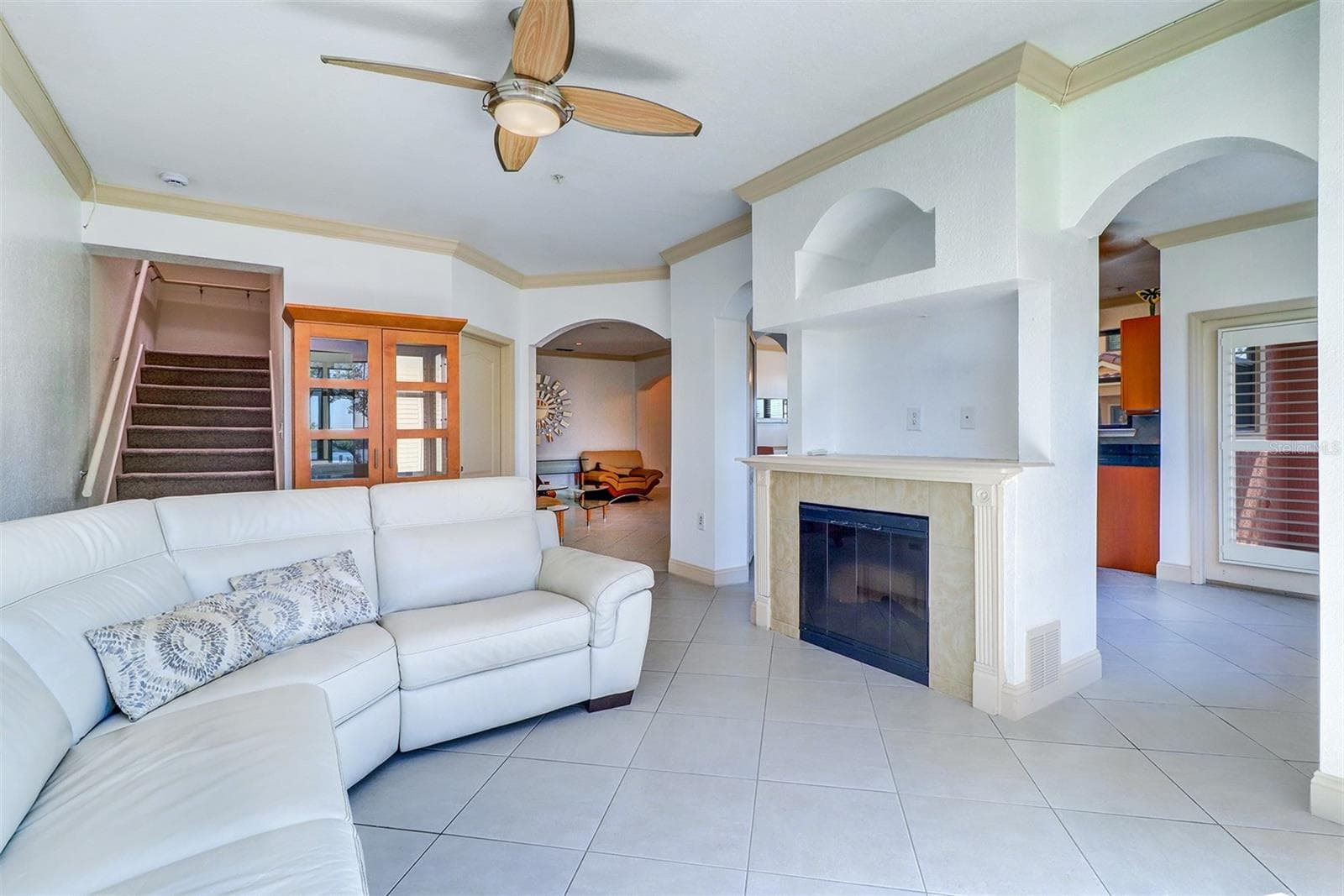 Family room with gas fireplace with the kitchen entry to the right and living area straight ahead - 2757 VIA CIPRIANI #1114A, CLEARWATER