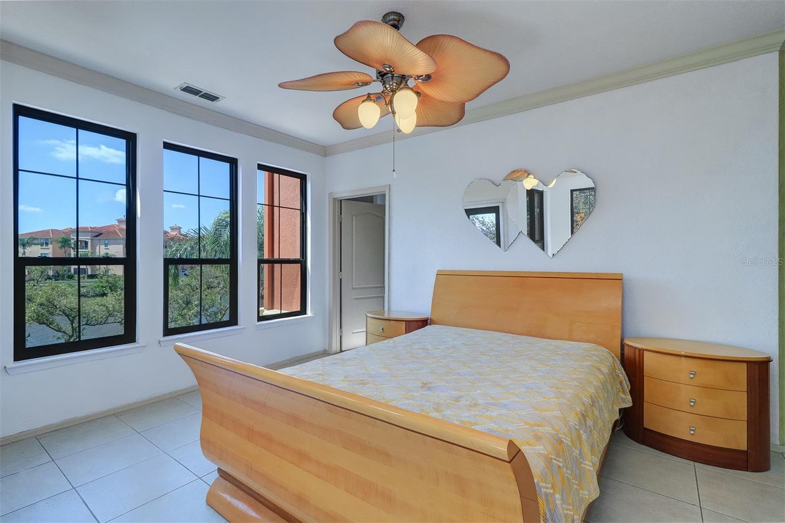 A wall of windows in the primary bedroom with gorgeous view - 2757 VIA CIPRIANI #1114A, CLEARWATER