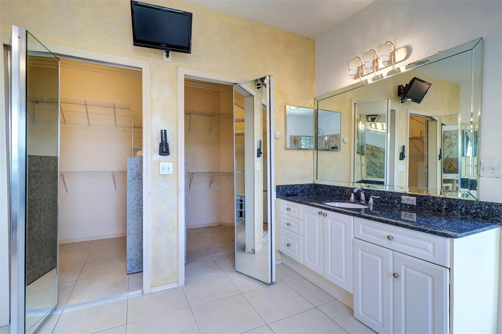 Second vanity and view of walk in closet with mirrored doors - 2757 VIA CIPRIANI #1114A, CLEARWATER