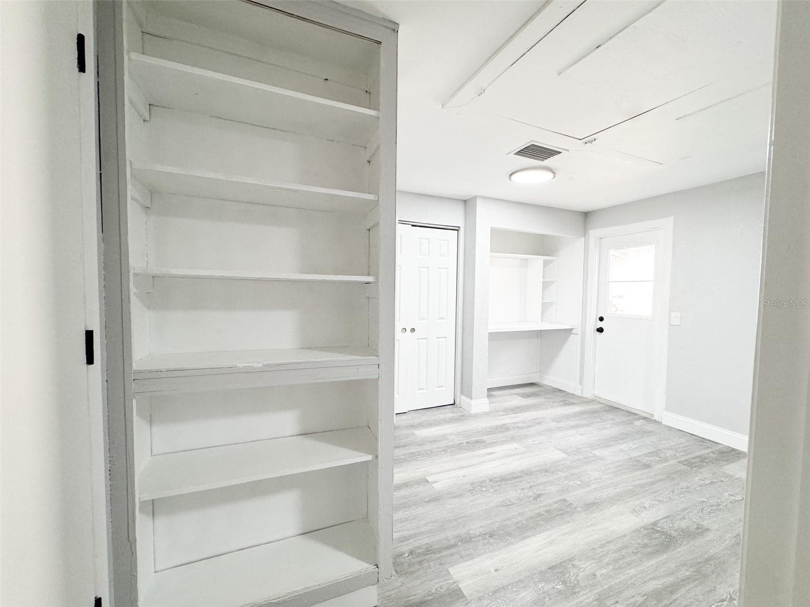Primary Closet #1, Work area and Bookshelf. - 10805 FILLMORE AVE, PORT RICHEY