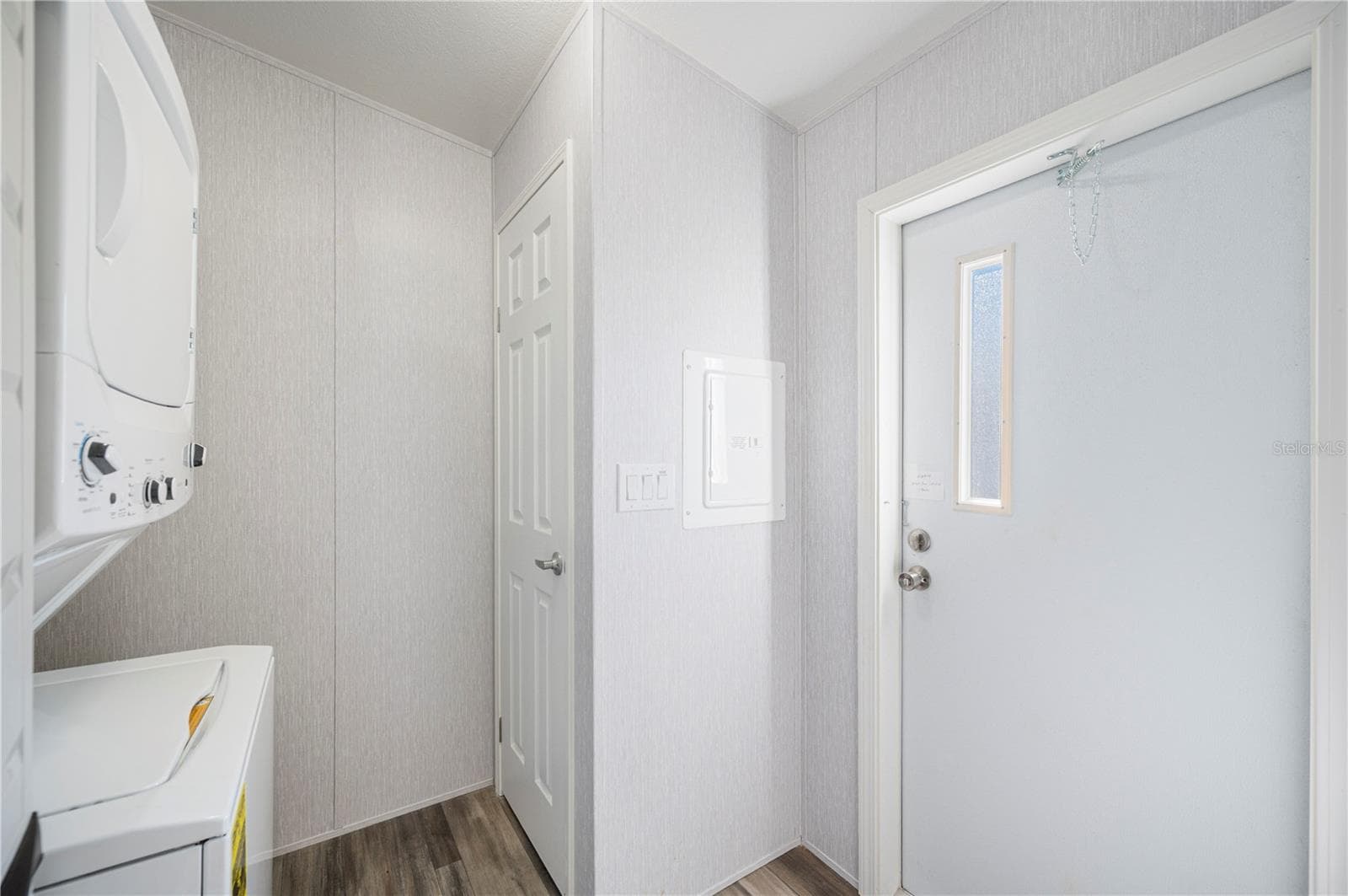 Laundry room with stacked washer and dryer - 1 BEAVERKILL DR, LAKE WALES