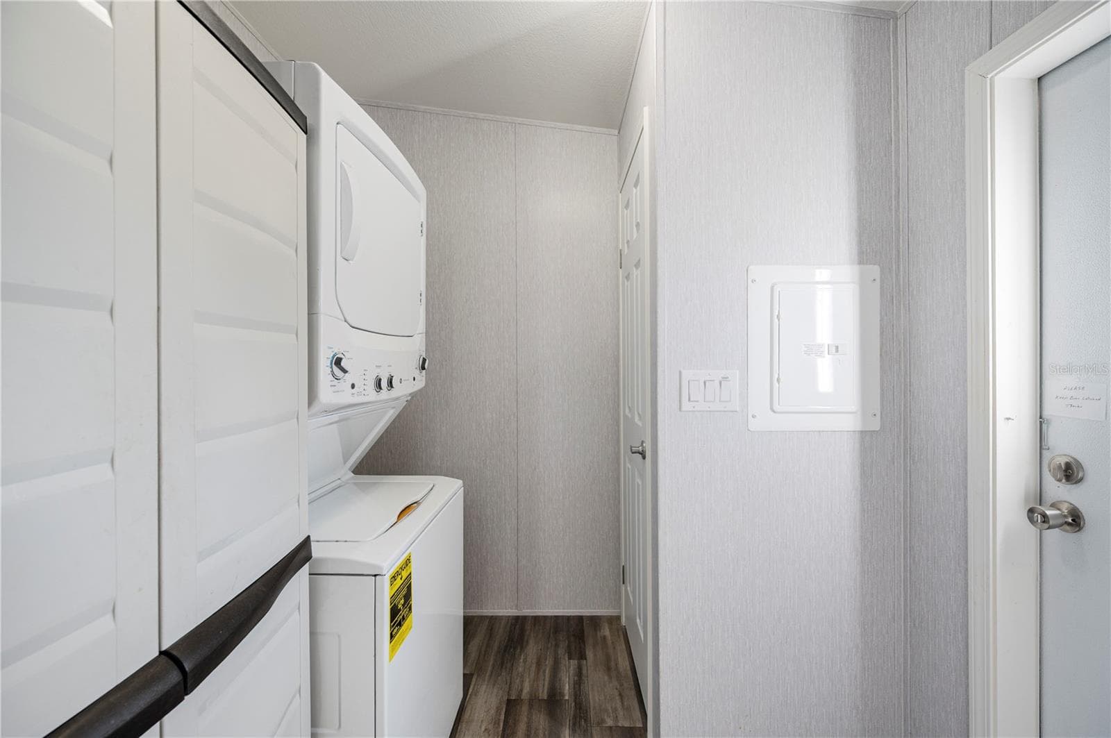 Laundry room with stacked washer and dryer - 1 BEAVERKILL DR, LAKE WALES