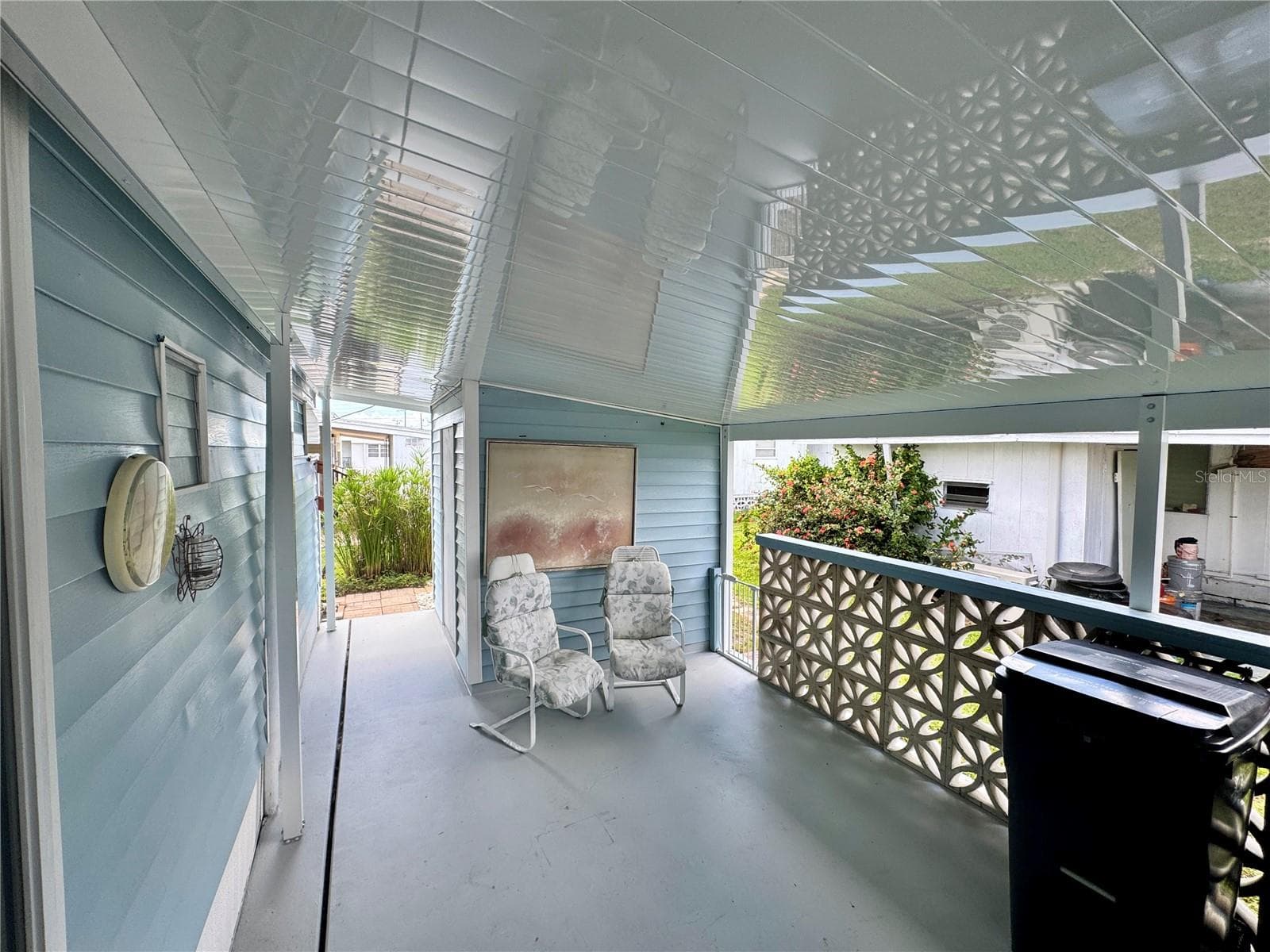 Carport with freshly painted drive and cement privacy fence - 616 50TH AVENUE TER W, BRADENTON