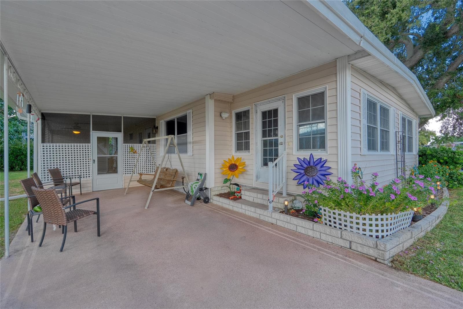 A Carport at the front of this home with an inviting entrance - 288 SALEM AVE #3, PALM HARBOR