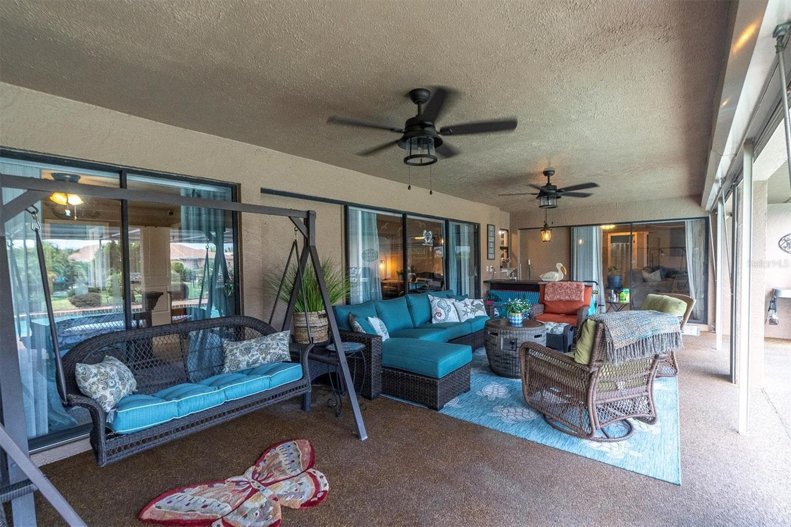 Covered lanai with ceiling fans - 301 THORN HILL PL, SUN CITY CENTER