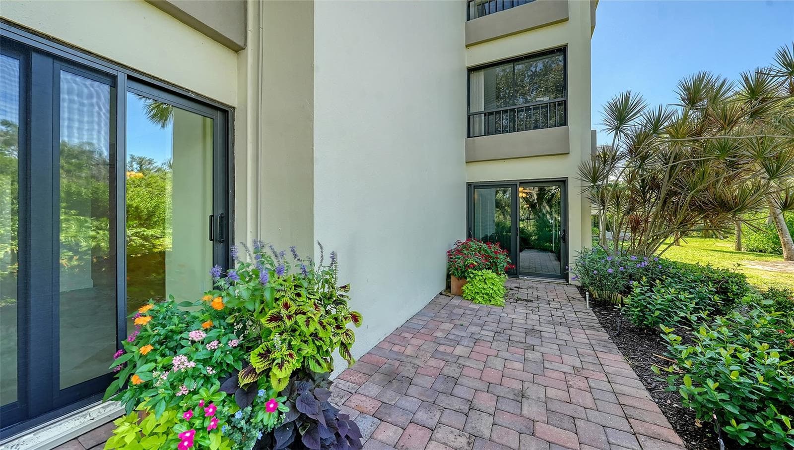 Private brick paver patio facing the lagoon is a unique feature of this unit. - 225 HOURGLASS WAY #103, SARASOTA