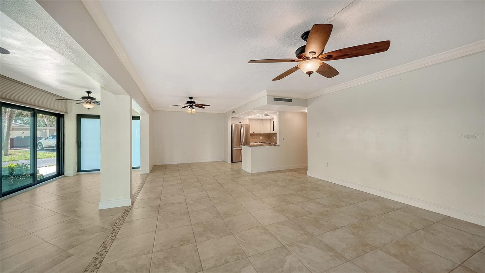 View from living room to the dining space and kitchen. - 225 HOURGLASS WAY #103, SARASOTA