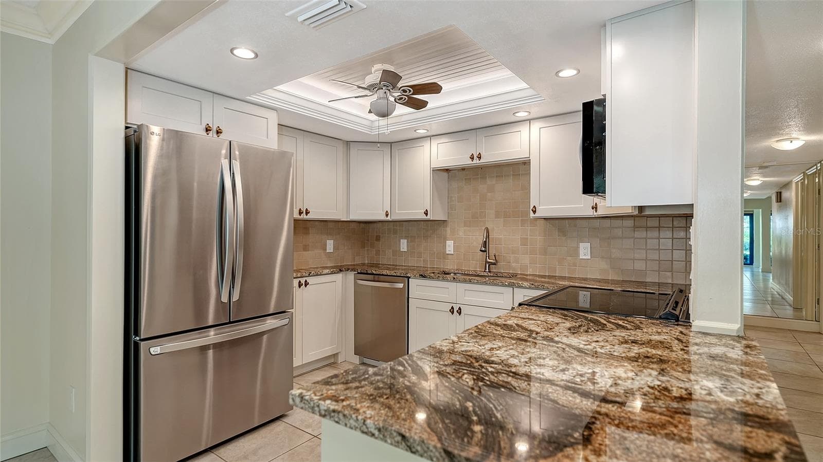New 2025 kitchen with granite counters, stainless LG appliances, new soft close cabinetry & recessed lighting. - 225 HOURGLASS WAY #103, SARASOTA