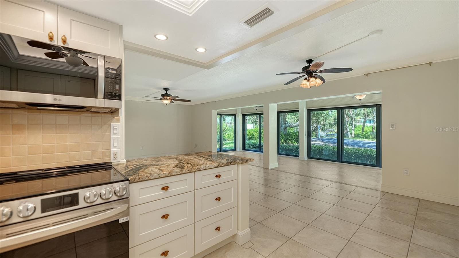 Breakfast bar opens to living and dining spaces. - 225 HOURGLASS WAY #103, SARASOTA