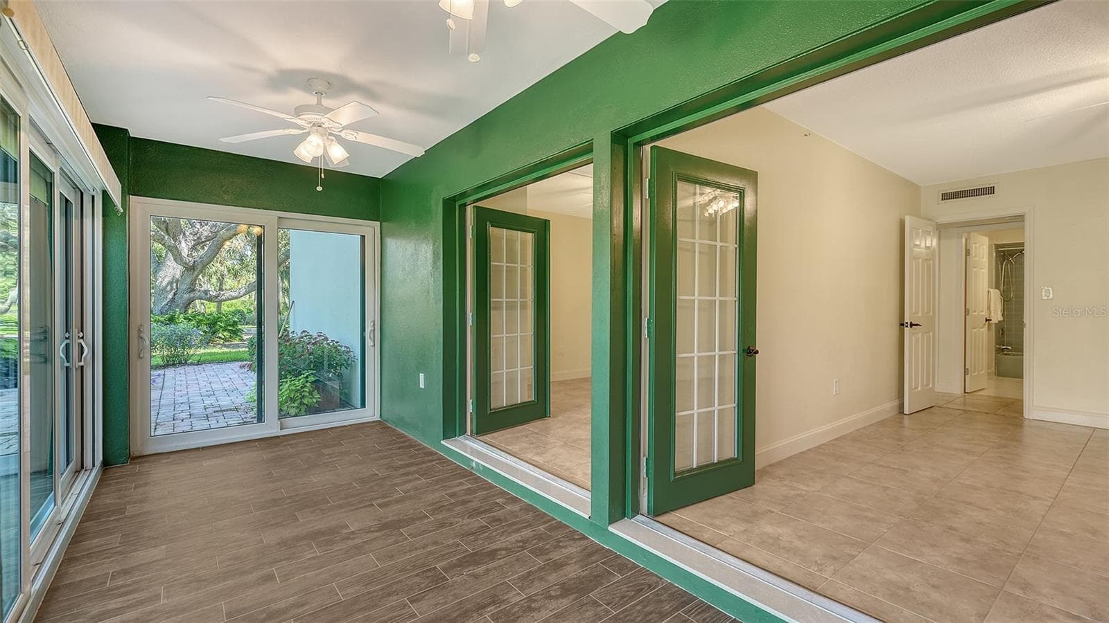 French doors open from both bedrooms into the enclosed lanai. - 225 HOURGLASS WAY #103, SARASOTA