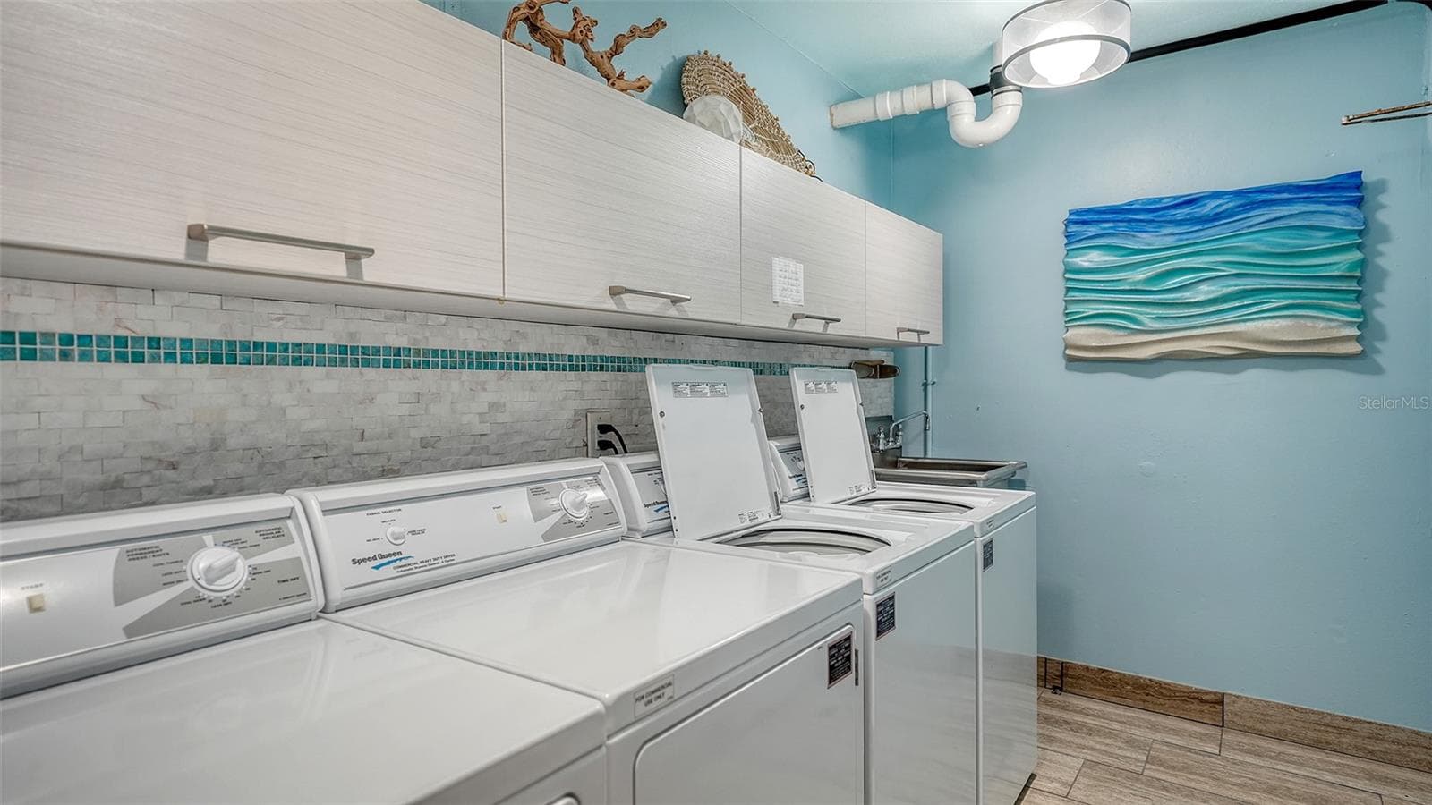 Common laundry room on same floor includes 2 sets of coinless WDs, & owner storage cabinets. - 225 HOURGLASS WAY #103, SARASOTA