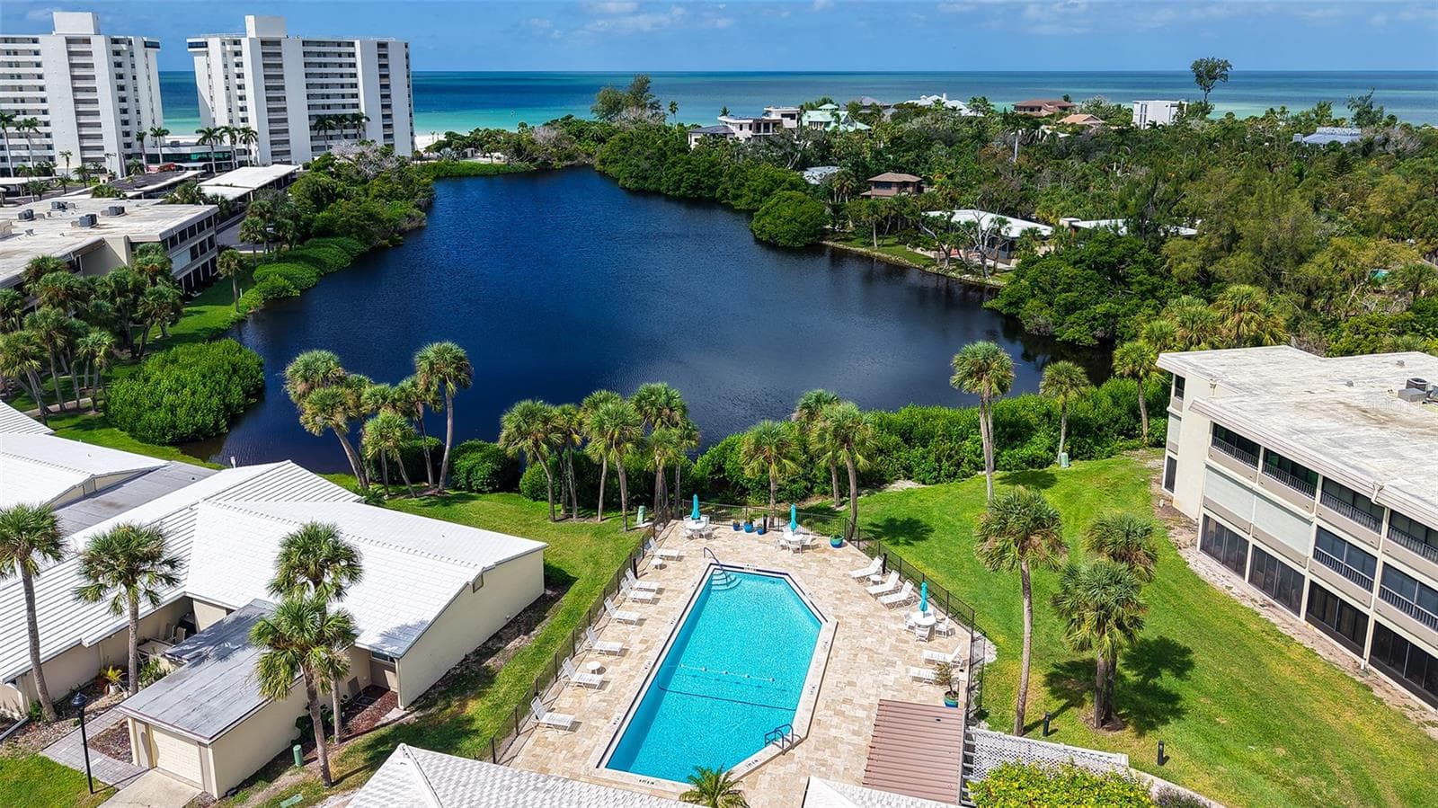 Main clubhouse pool features new 2025 deck pavers. - 225 HOURGLASS WAY #103, SARASOTA