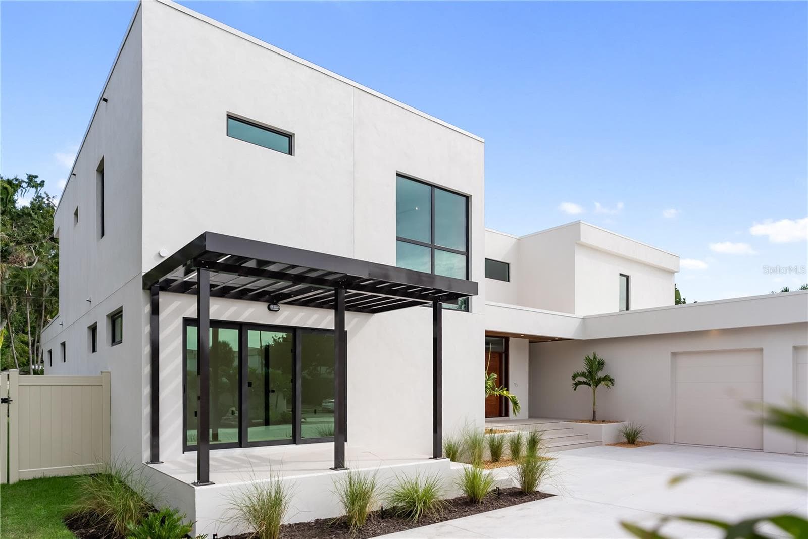 Front patio with elegant trellis detail and direct access to the office through sliding glass doors - 1759 WALDEMERE ST, SARASOTA