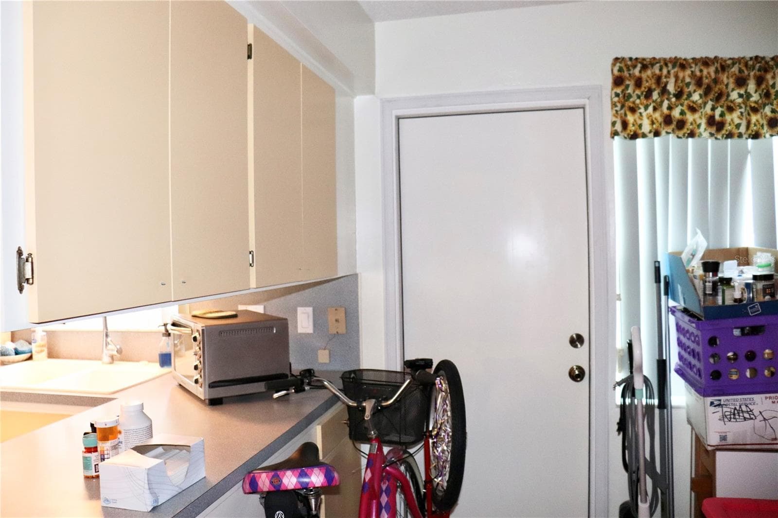 Back door off bonus area and additional kitchen cabinets for storage - 6990 VERSAILLES N #6990, PINELLAS PARK