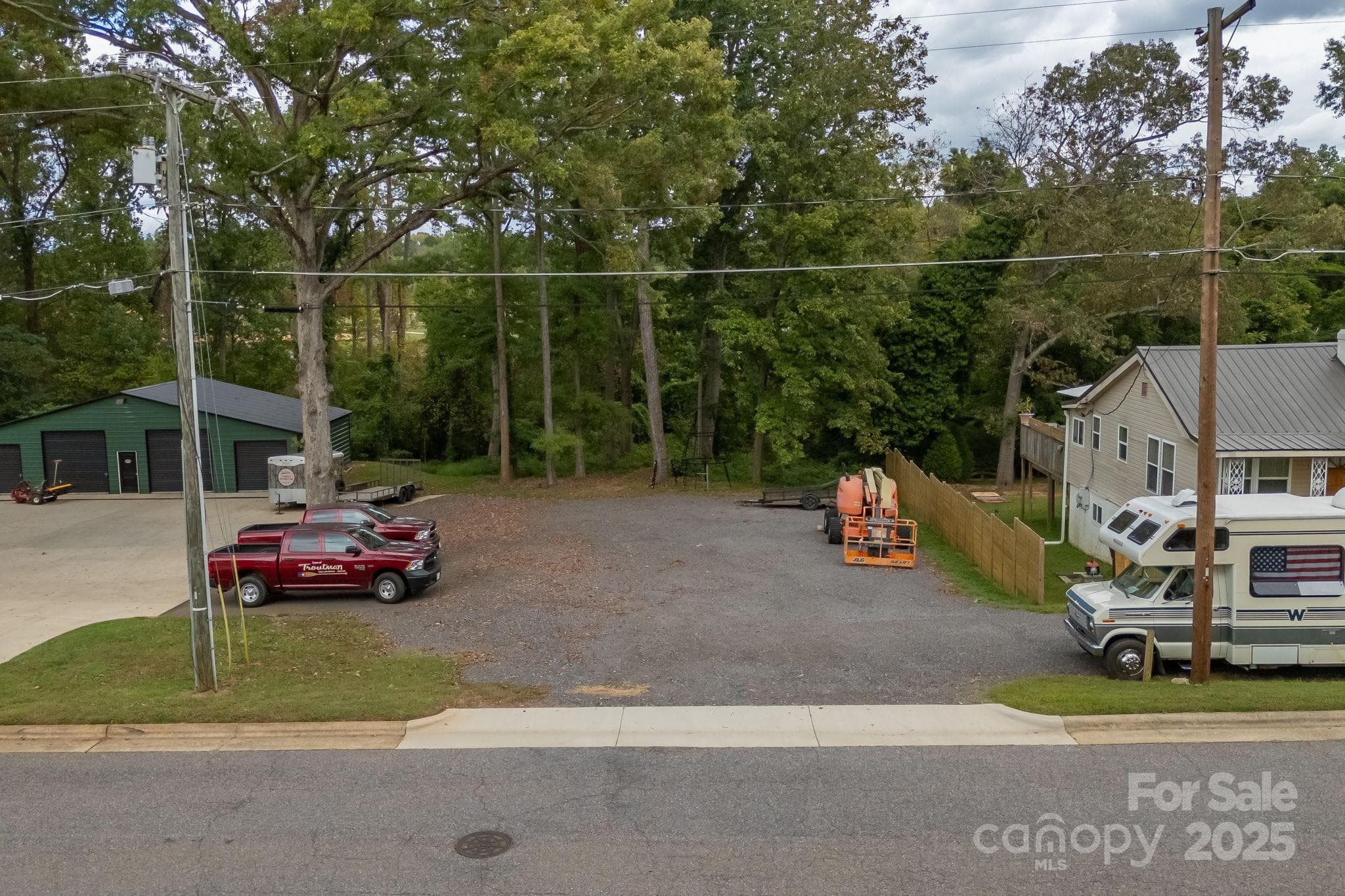 property line runs with the telephone line behind the home with RV. - Troutman