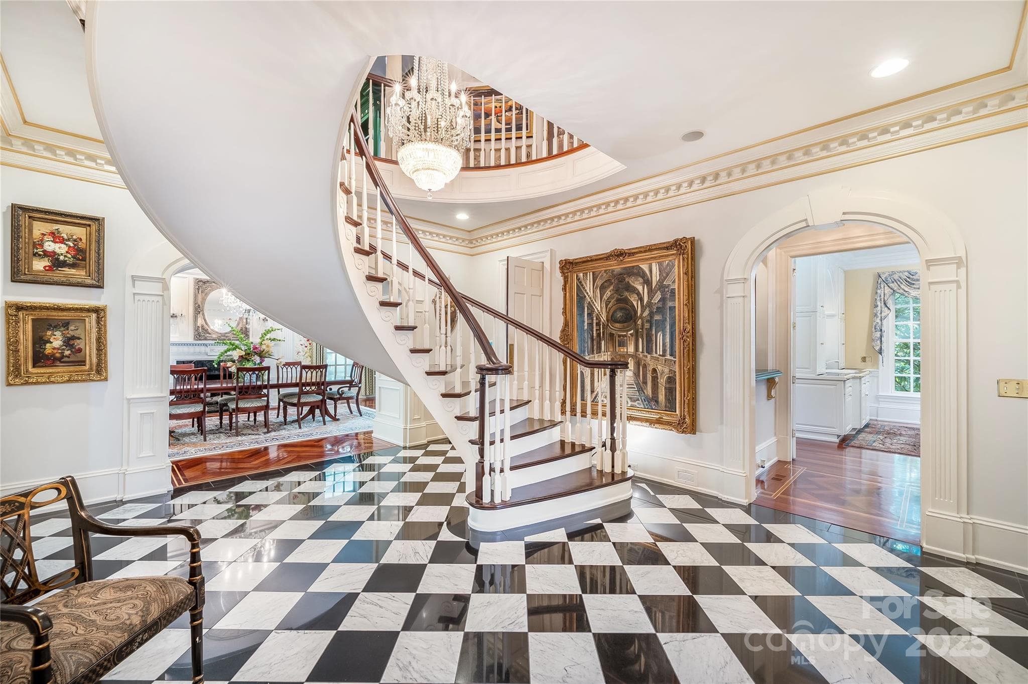 Suspended spiral staircase showcases the architectural details throughout the home. - 2665 Rolling Hills Drive, Monroe