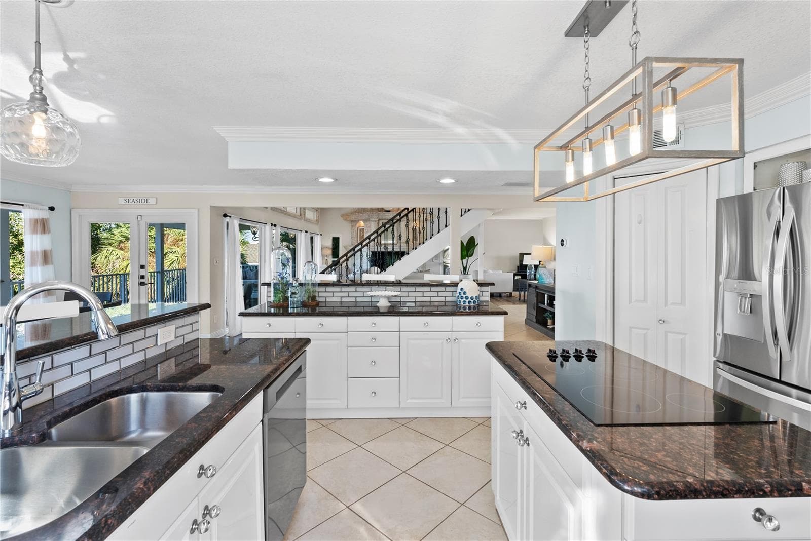 Chef’s kitchen with granite counters and stainless steel appliances upgraded lighting. - 255 46TH AVE, ST PETE BEACH