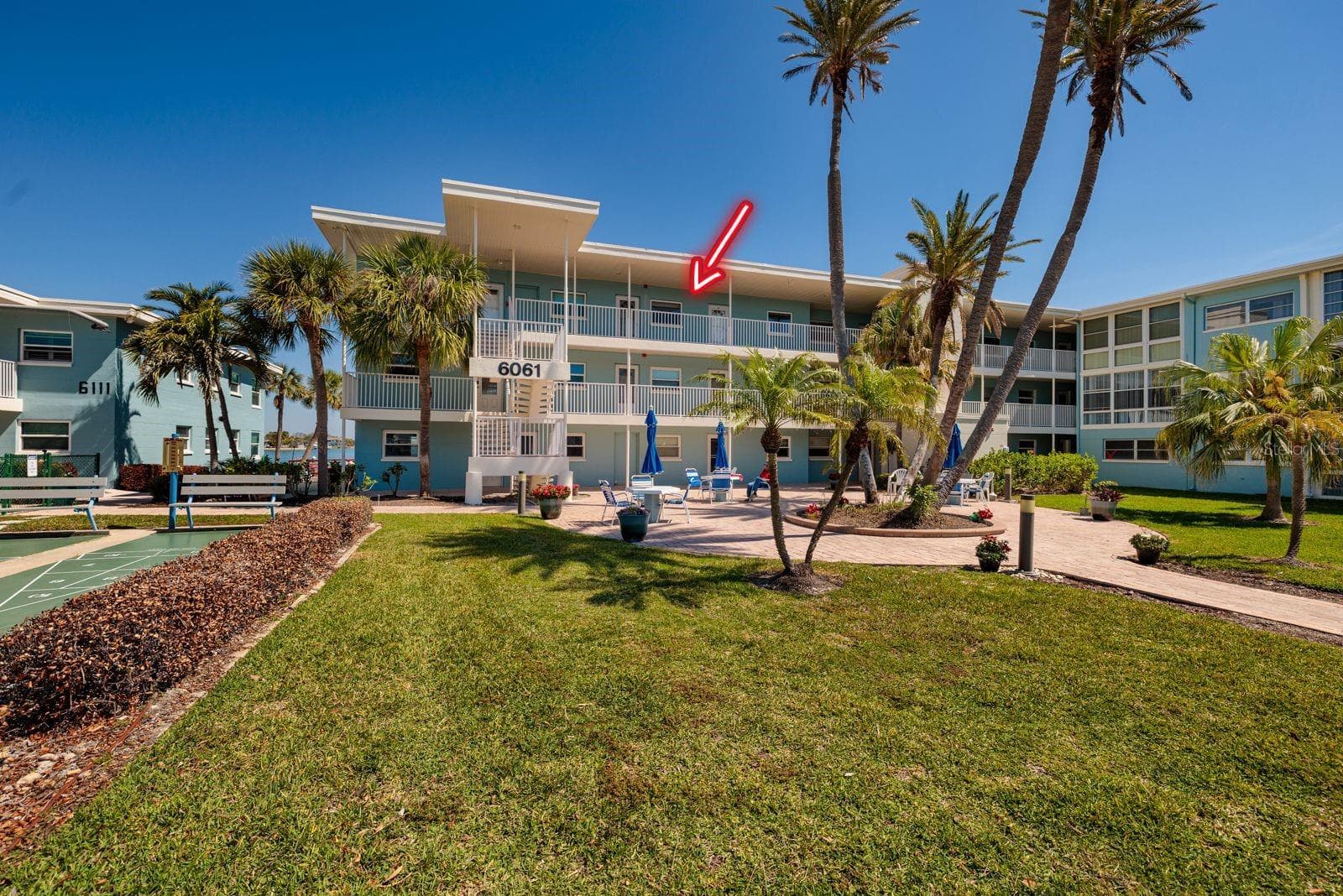 Top floor unit with courtyard & sunset views from the front walkway/porch. - 6061 2ND ST E #55, ST PETE BEACH