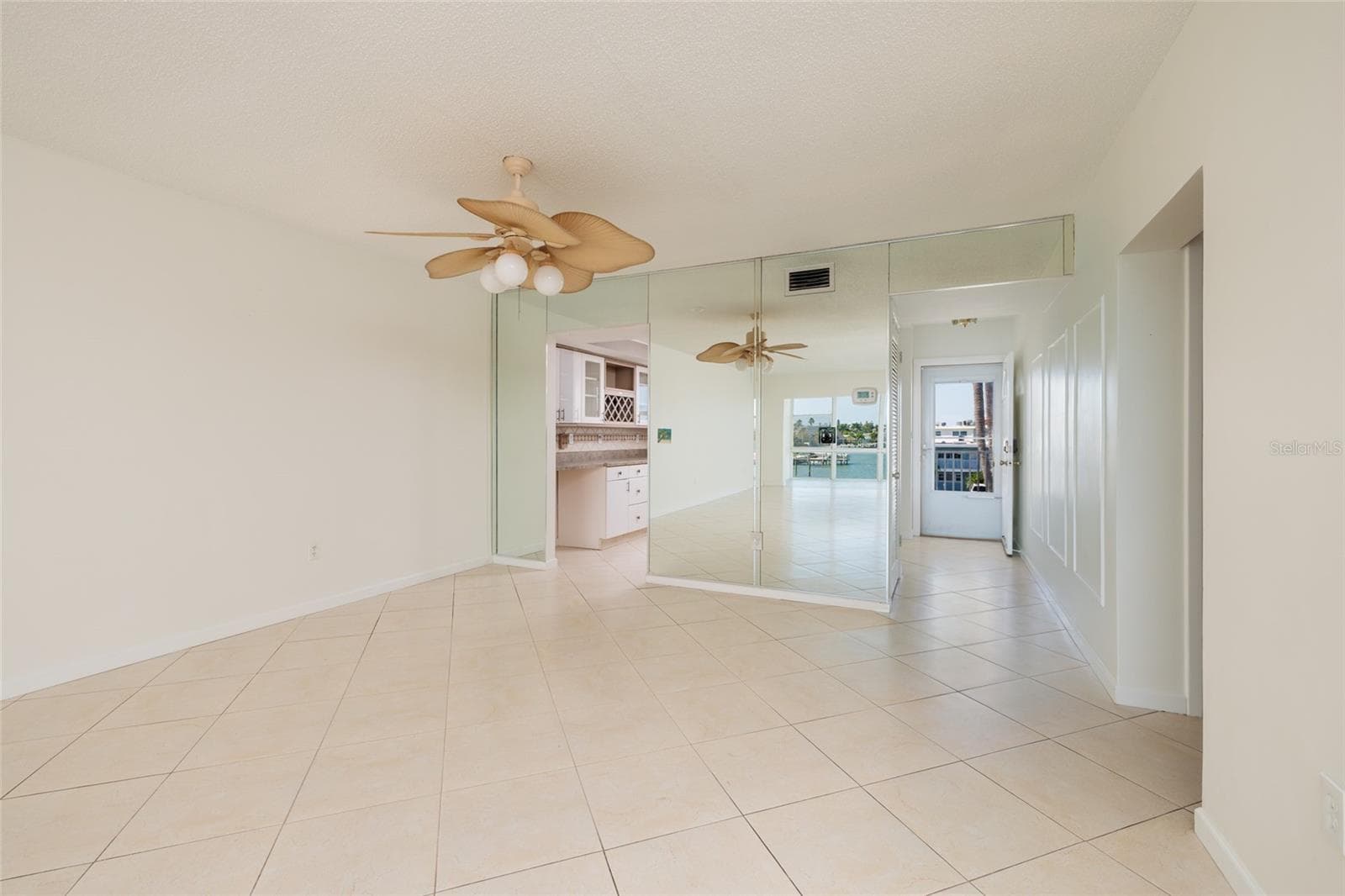 Dining area, Kitchen on left. 2nd bedroom & bathroom entrance on far right. Foyer & front door. - 6061 2ND ST E #55, ST PETE BEACH