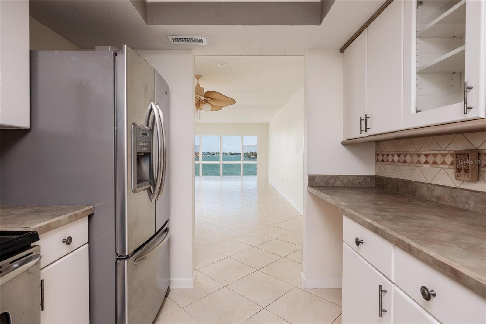 Kitchen w/Bay views though doorway. - 6061 2ND ST E #55, ST PETE BEACH