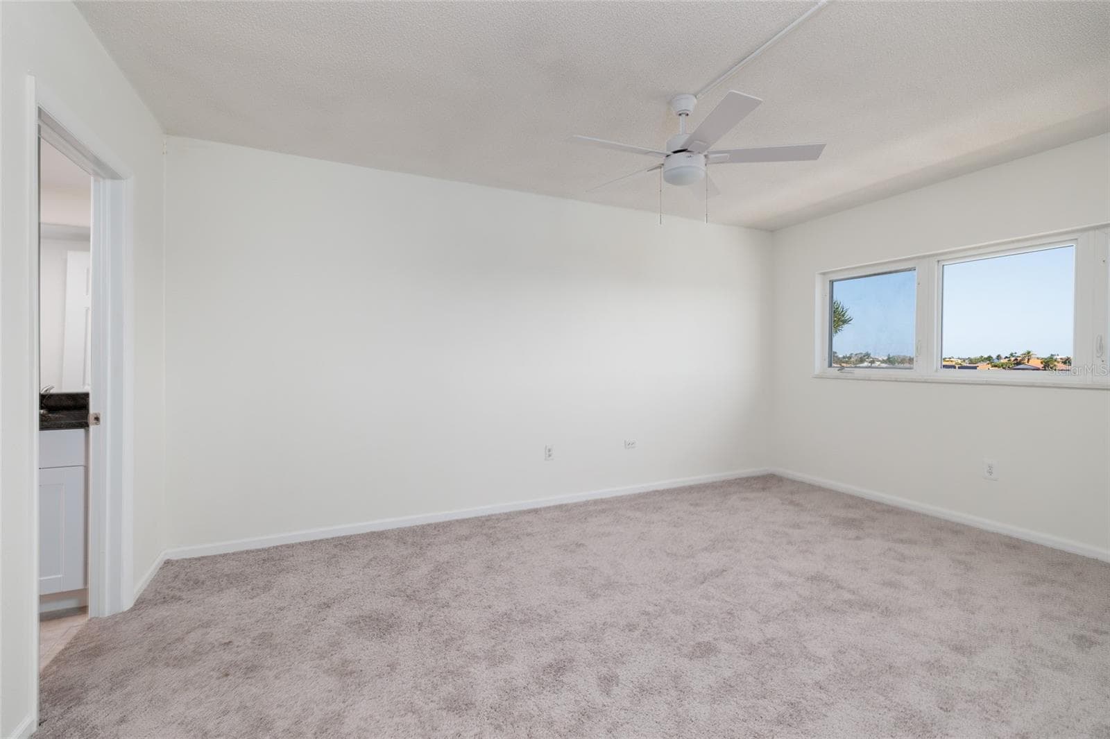 Primary bedroom w/Bay views & en-suite bathroom on left. Large walk-in Closet. - 6061 2ND ST E #55, ST PETE BEACH