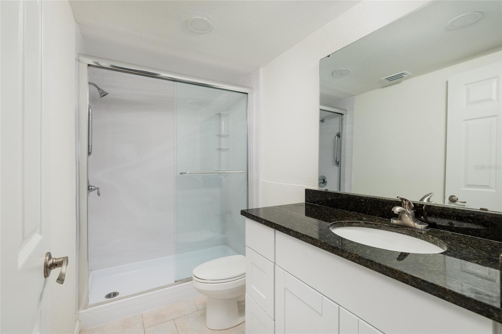 Primary bathroom w/shower & exhaust fan. - 6061 2ND ST E #55, ST PETE BEACH