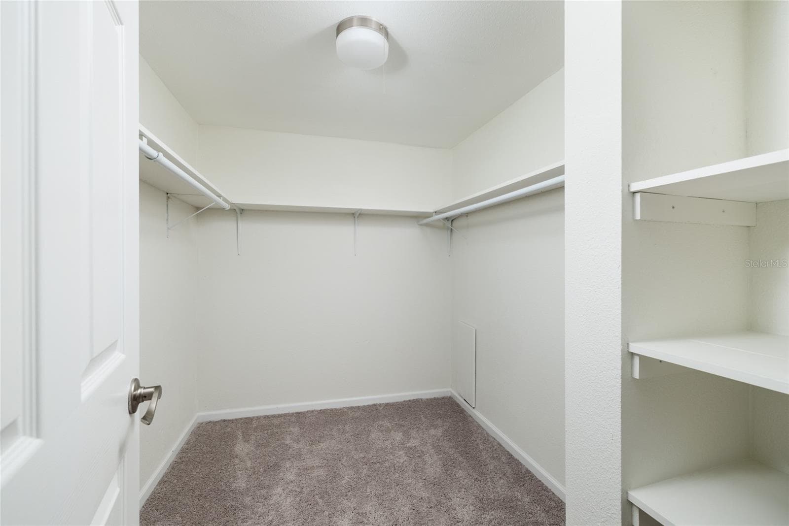 Primary bedroom walk-in closet. - 6061 2ND ST E #55, ST PETE BEACH