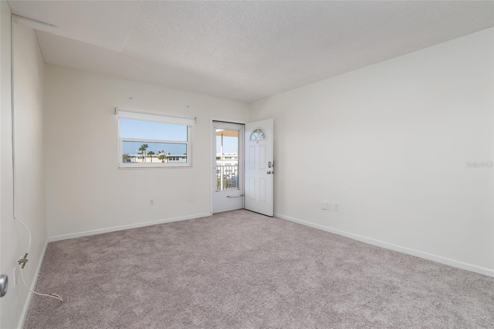 2nd bedroom w/Door to the front covered walkway/porch. - 6061 2ND ST E #55, ST PETE BEACH
