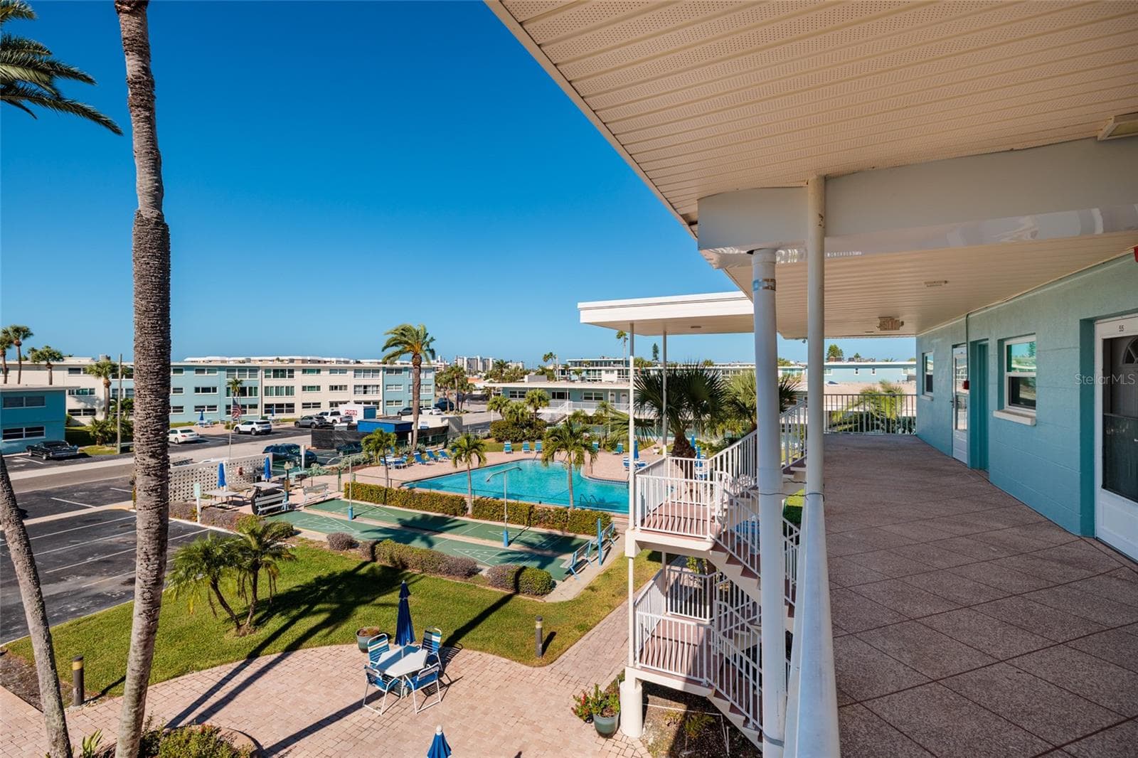 Courtyard w/Swaying palms & pool. Grilling area & shuffle board courts. - 6061 2ND ST E #55, ST PETE BEACH