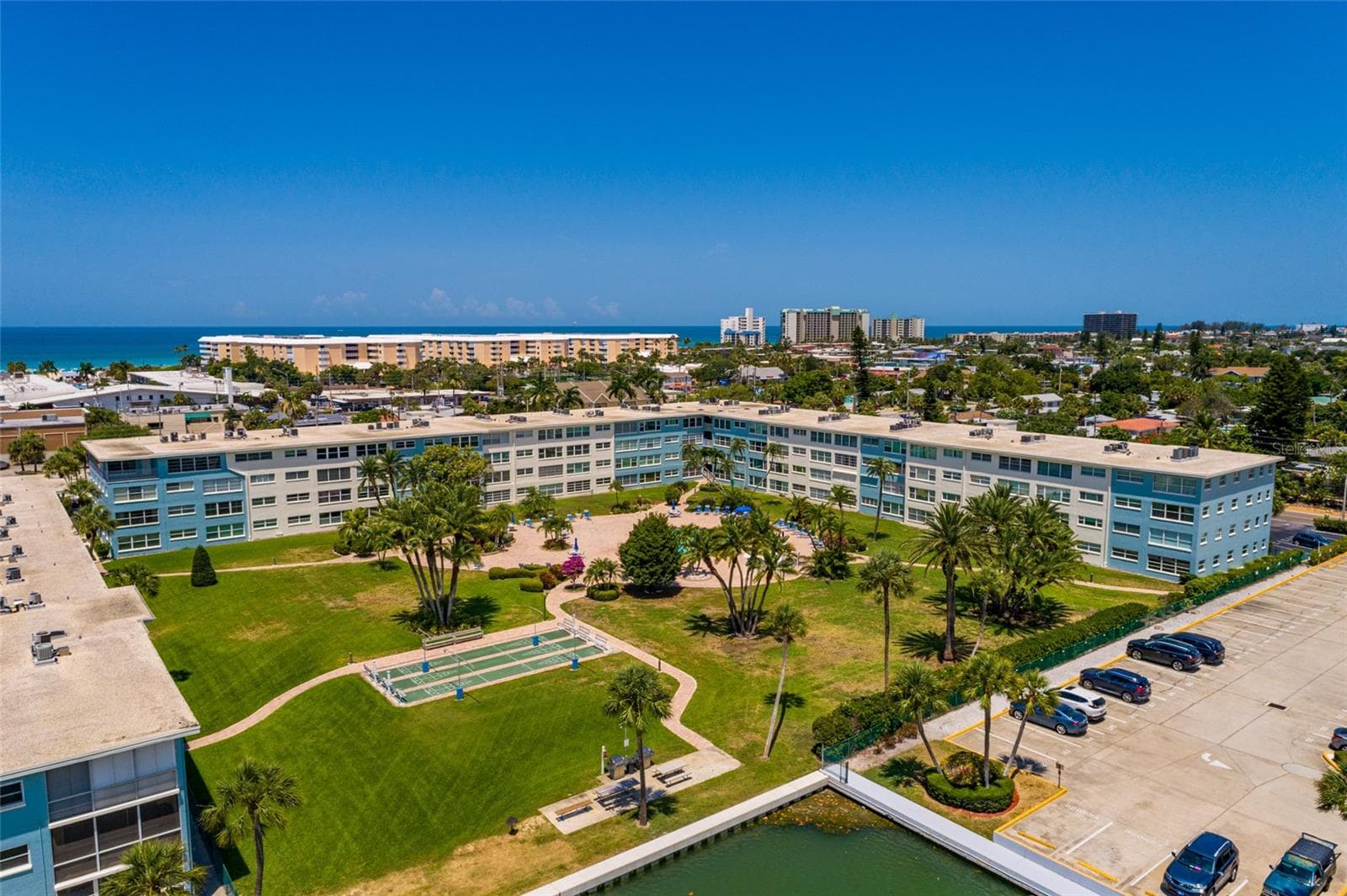 North pool courtyard & grilling area is waterfront. - 6061 2ND ST E #55, ST PETE BEACH