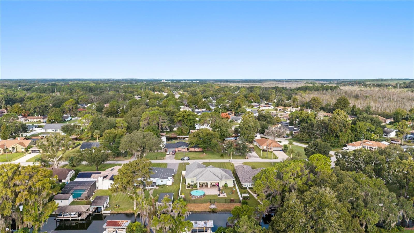 Back of the house with access to the canal that leads to Lake Eustis - 35638 CALLA CT, LEESBURG