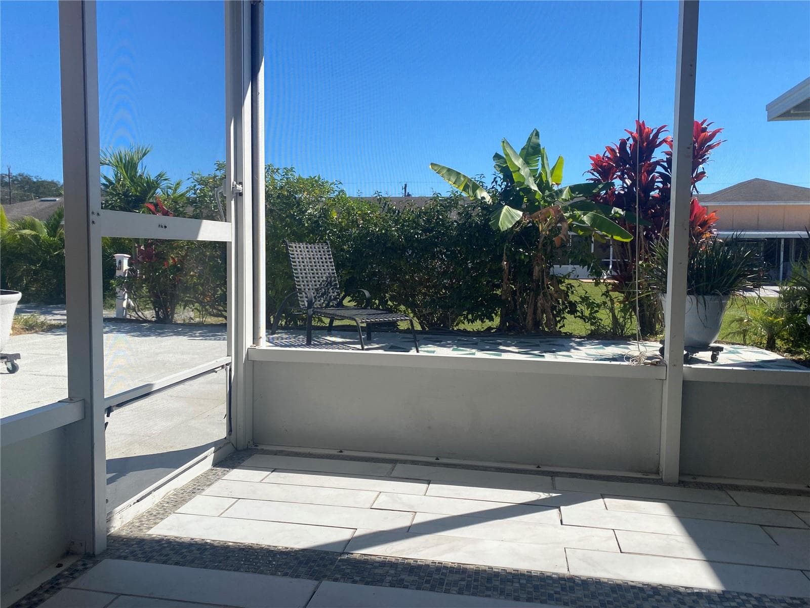 Back screened porch opens to a private courtyard - landscaping provides the privacy. - 4409 CLUB CIR, LAKE WALES