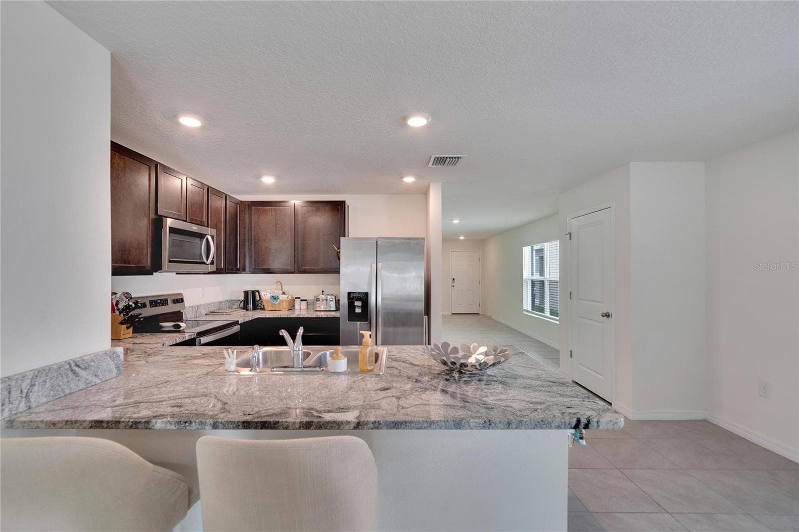 Kitchen view from Family Room - 5547 LOGAN CAVE AVE, WIMAUMA