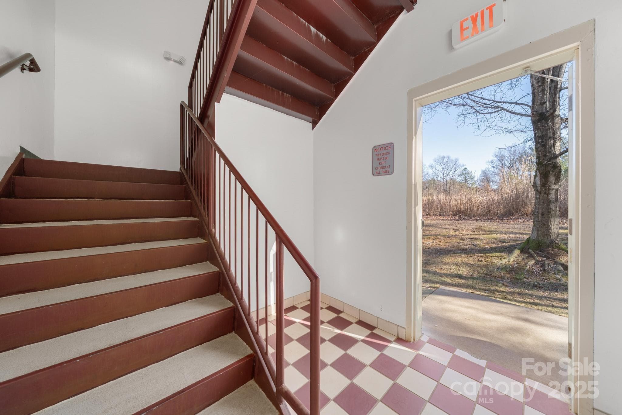Stairs to second floor. Opens to Lot D, perfect for building a larger building and connecting with a breezeway. - Hendersonville