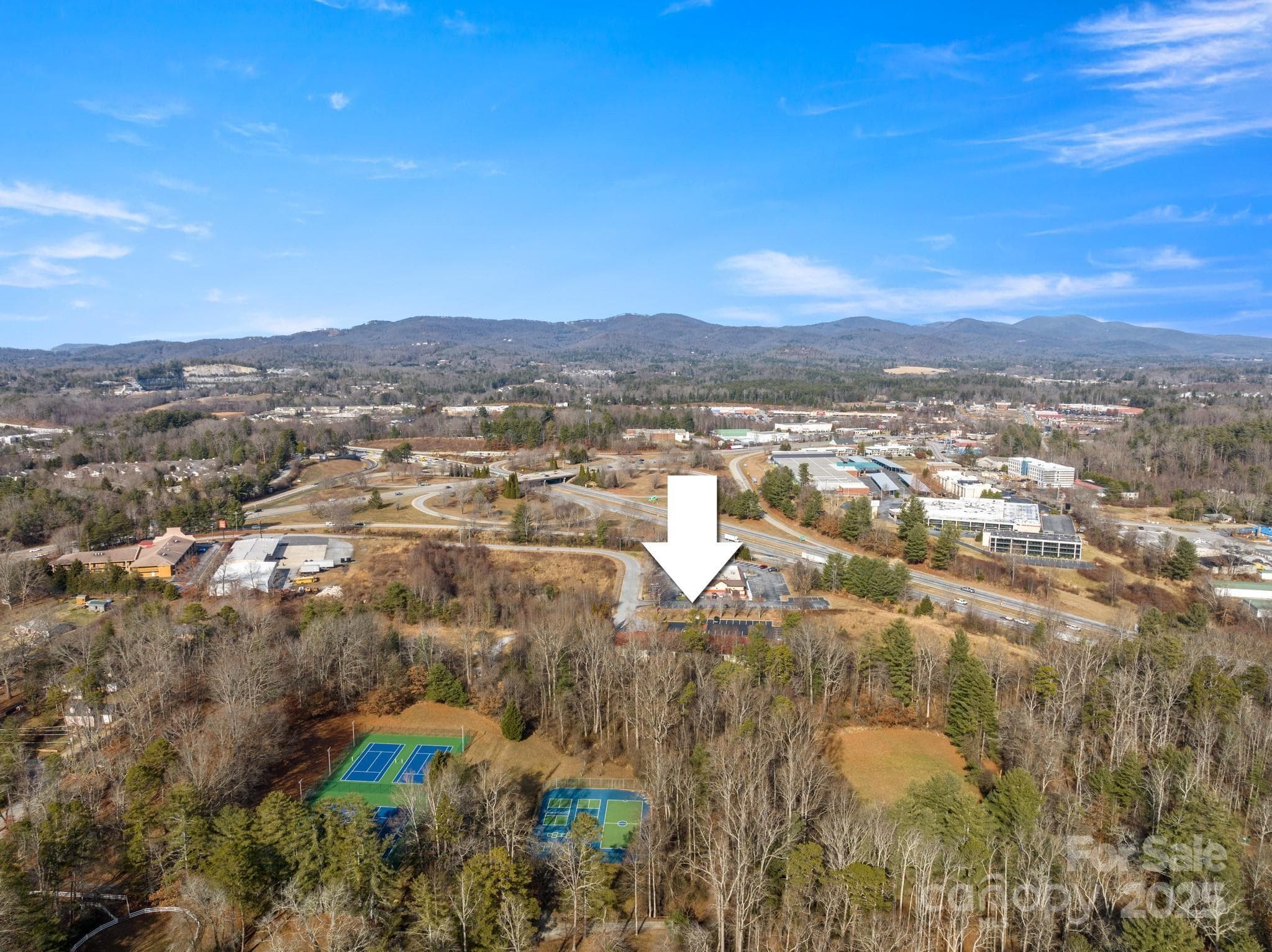 Behind the Red Roof Inn and additional lots is a camp. - Hendersonville